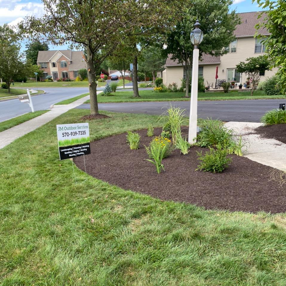 JM Outdoor Services project sign and landscape bed