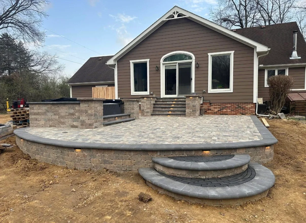 Finished paver patio with retaining walls and curved steps
